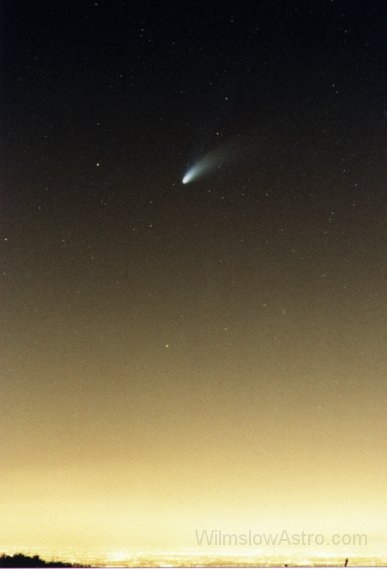 halebopp3.jpg -    Object:   Comet HaleBopp     Date:        Instrument:   Camera lens     Camera:   35mm film camera     Exposure:        Filters:   None     Comments:   A view of Hale-Bopp taken from Rainow looking over Manchester. I have included this to show what sort of light pollution we have to put up with in this part of the world.  